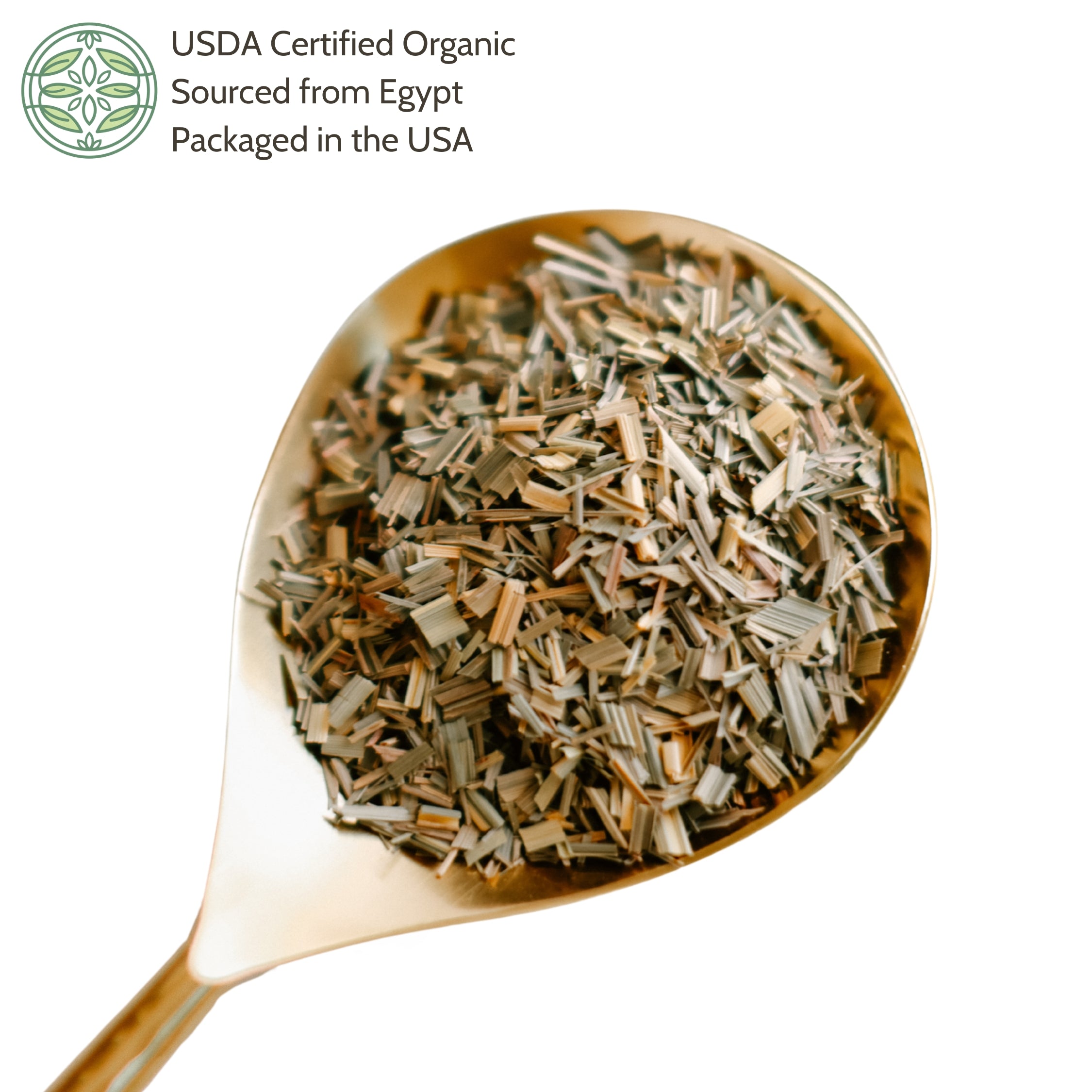 Gold spoon filled with dried lemongrass on a white background