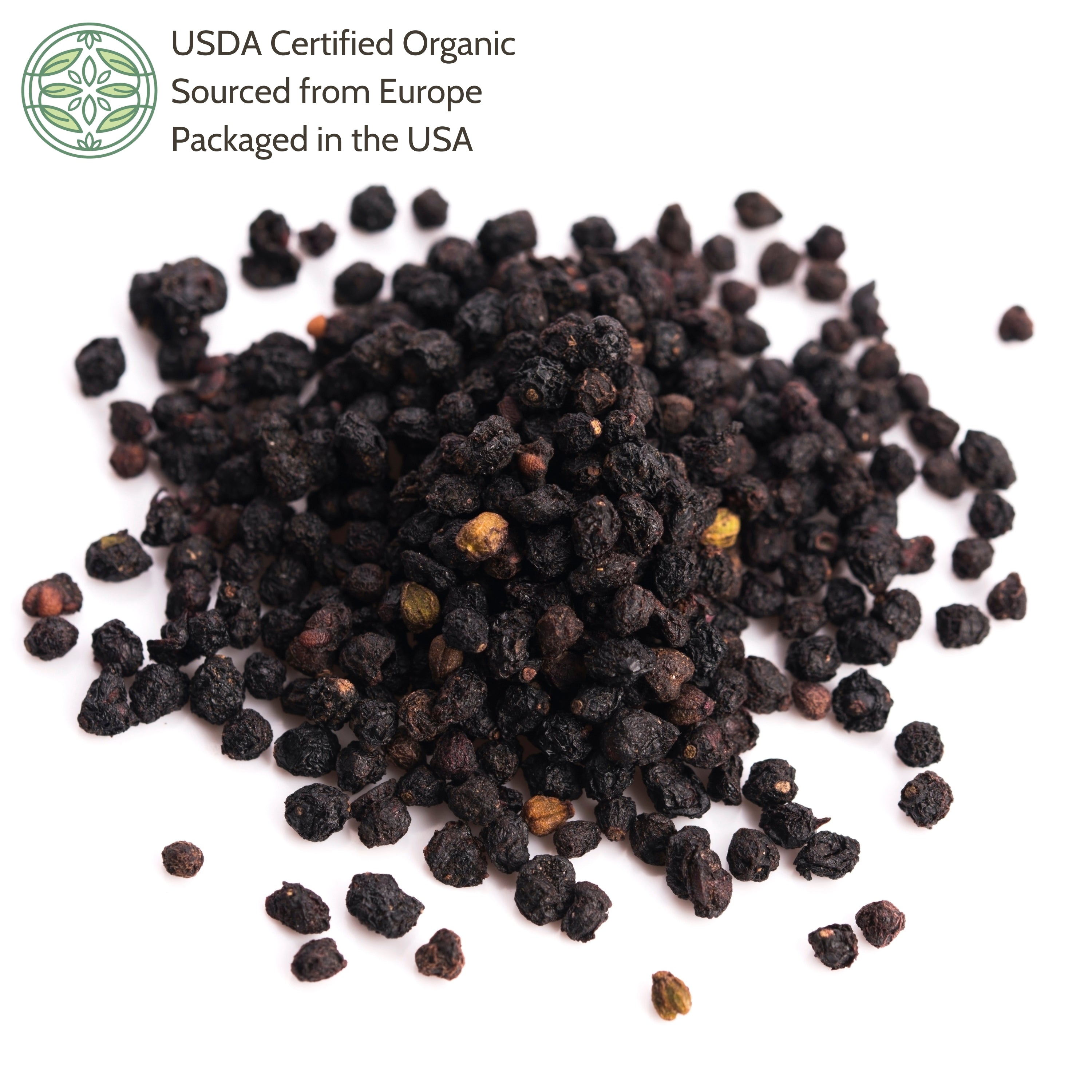 Pile of black elderberries on a white background