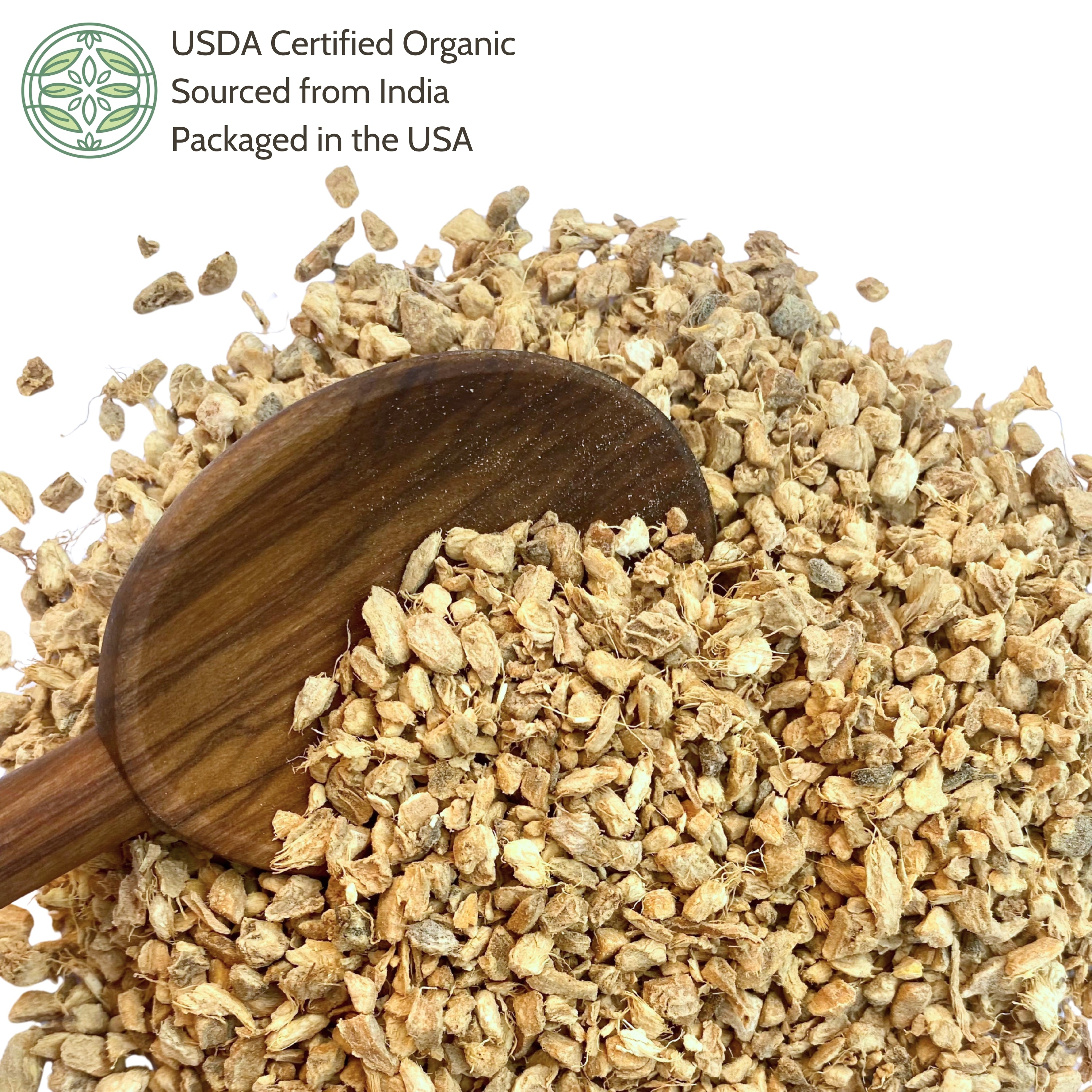 Dry ginger with a wooden spoon on a white background