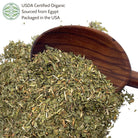 Wooden scoop filled with dried alfalfa leaf