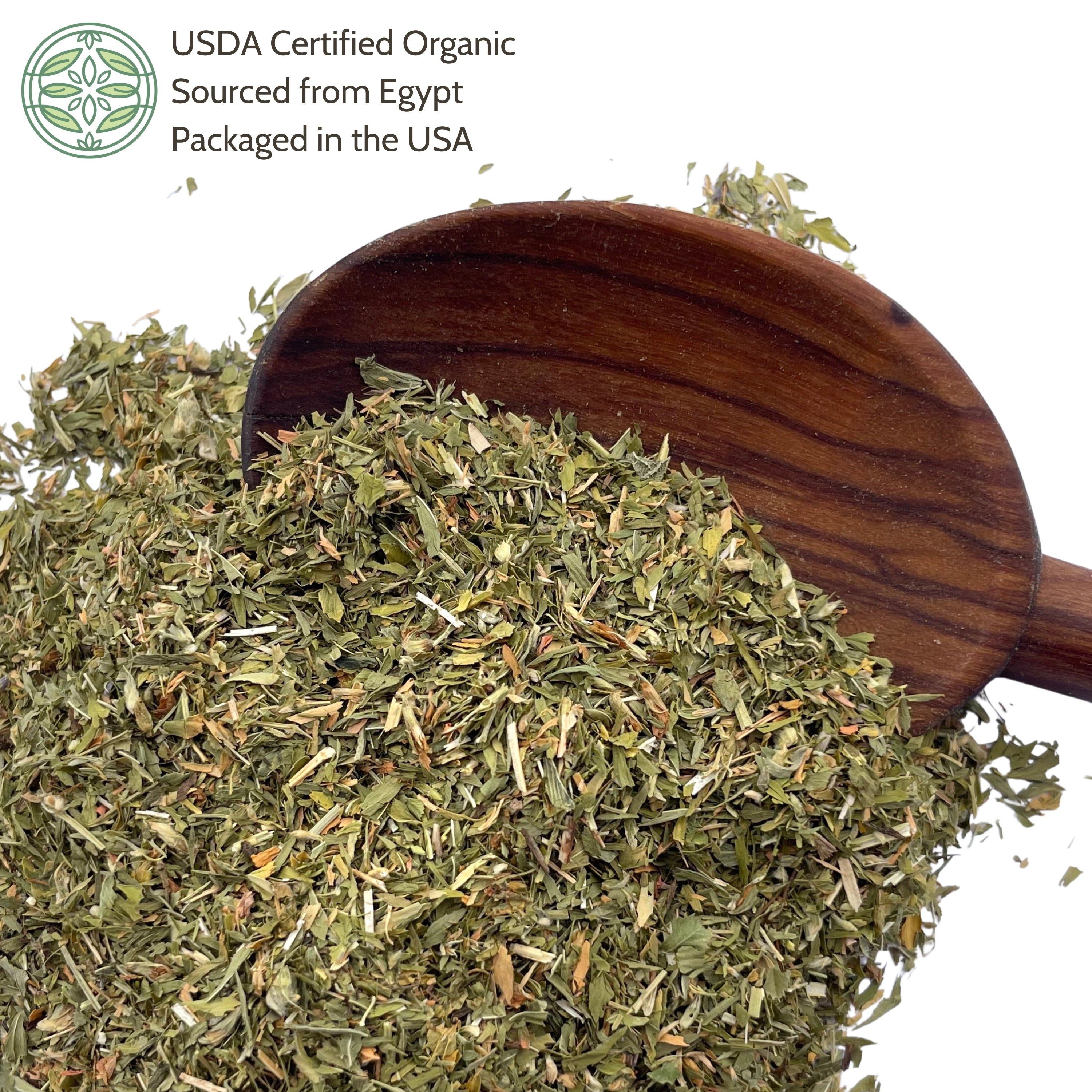 Wooden scoop filled with dried alfalfa leaf
