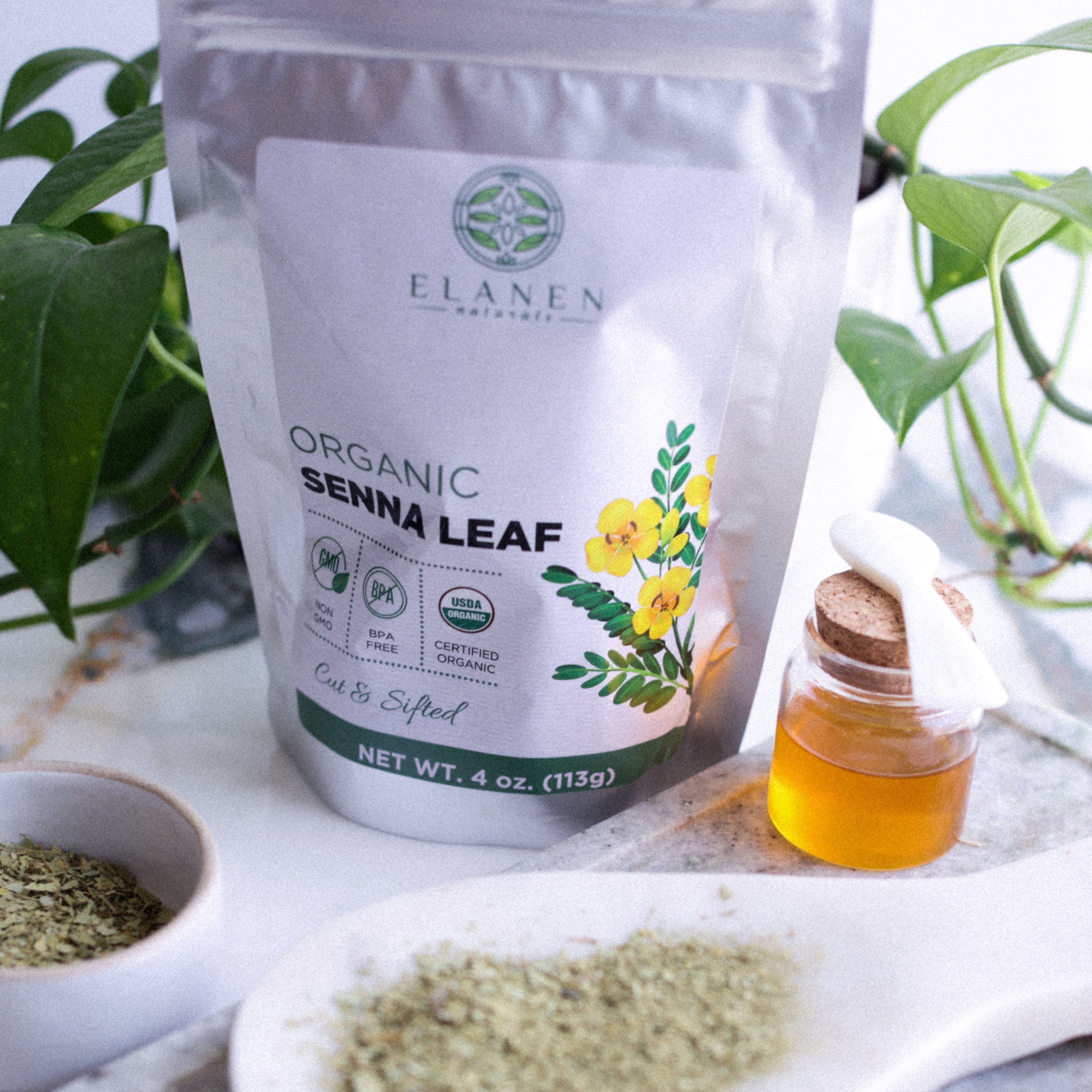 Elanen Organic Senna Leaf packaging with herbs and a jar on a white surface