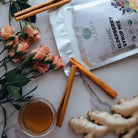 Elane Organic Elderberry Syrup Mix package with ginger, honey, and cinnamon on a marble surface.