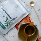Elanen Organic Chasteberrries package on a table with a cup and spoon.