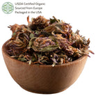 Wooden bowl filled with dried red clover.