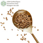 Gold spoon filled with astragalus root products on a white background.
