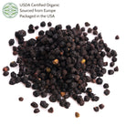Pile of black elderberries on a white background