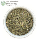 Bowl of dried herbs with USDA Certified Organic label on a white background