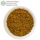 White bowl filled with yellowish-orange granules, labeled as USDA Certified Organic sourced from India and packaged in the USA.