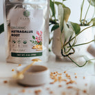 Elanen Organic Astragalus Root packaging on a light surface with plants in the background