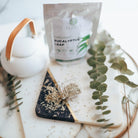 Tea set with Eucalyptus leaf packaging on a marble surface