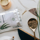 Elane Organic Horsetail package with a spoonful of dried horsetail on a marble surface.