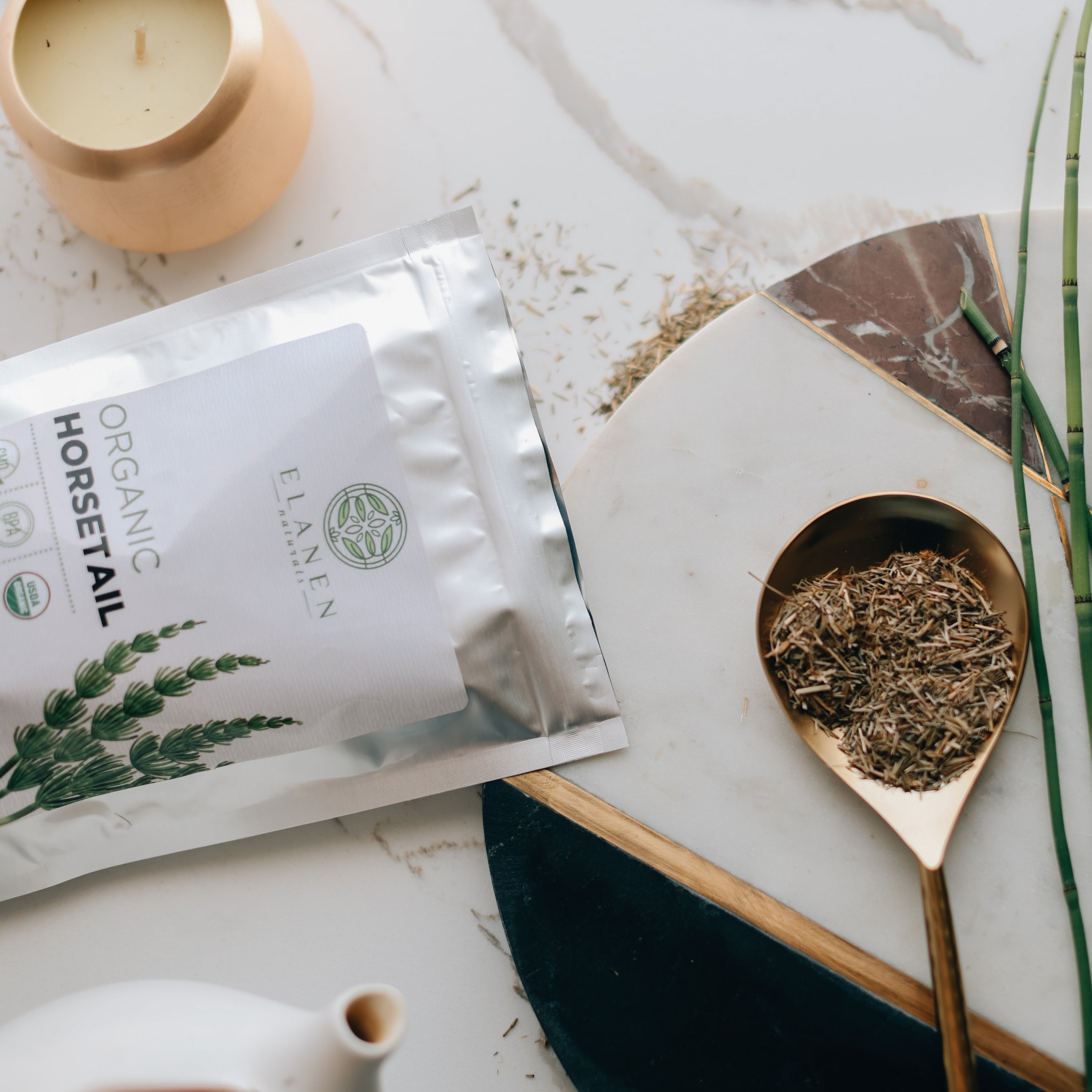 Elane Organic Horsetail package with a spoonful of dried horsetail on a marble surface.